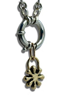 Load image into Gallery viewer, Silver chain with a gold flower-shaped pendant on a white background