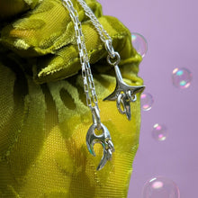 Load image into Gallery viewer, silver pierced star charm and pierced tribal style charm held by hand wearing green cheetah glove