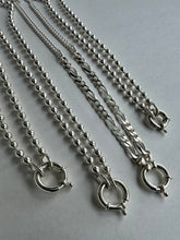 Load image into Gallery viewer, Six silver-toned chains with toggle clasp closures arranged diagonally on a light gray background. The chains include beaded, curb, and twisted link styles.

