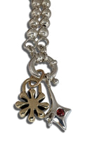 Load image into Gallery viewer, Silver necklace with charms on a white background
