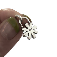 Load image into Gallery viewer, Silver flower-shaped earring held between fingers on a white background
